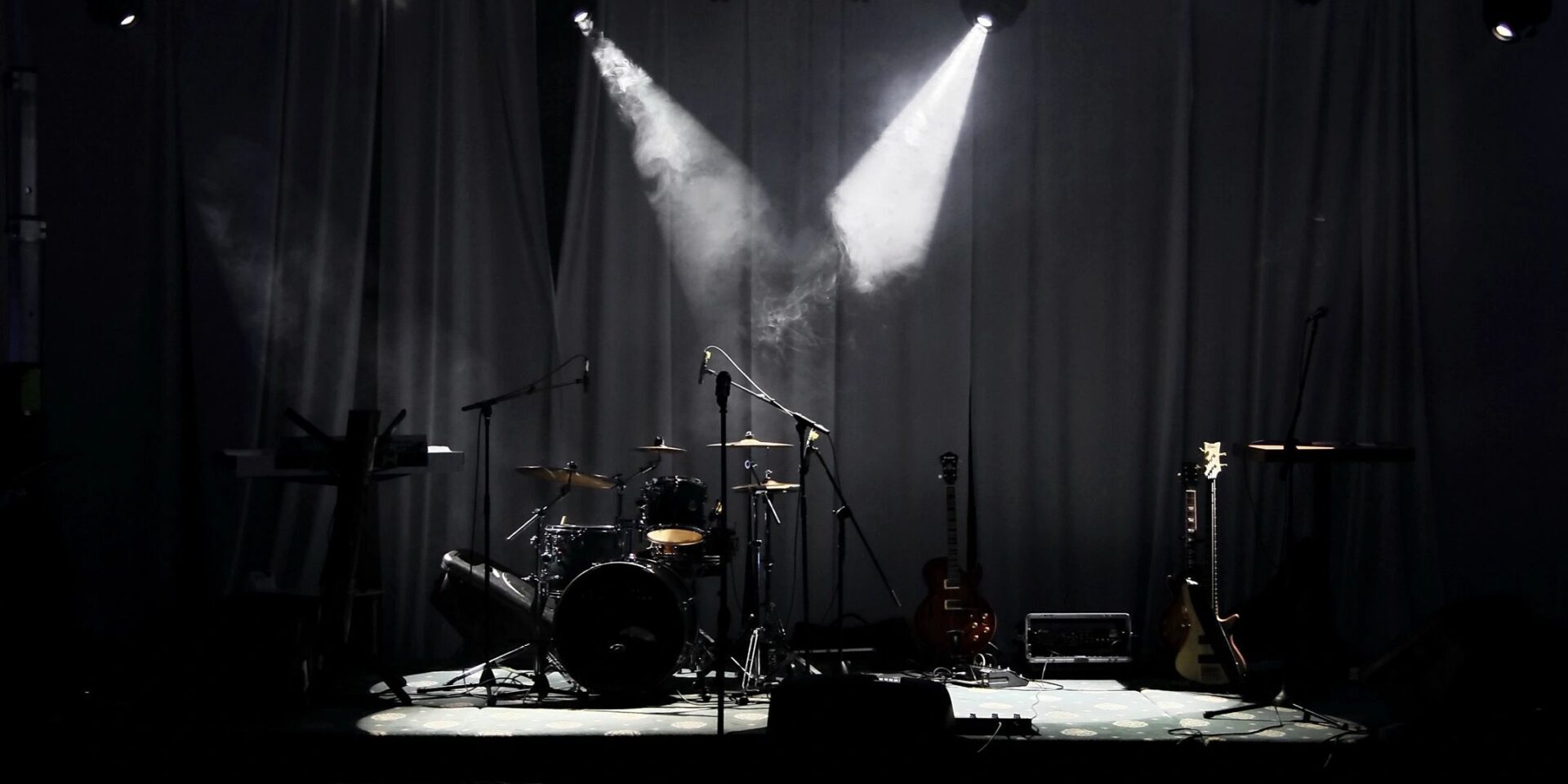 A stage with lights and a drum set.